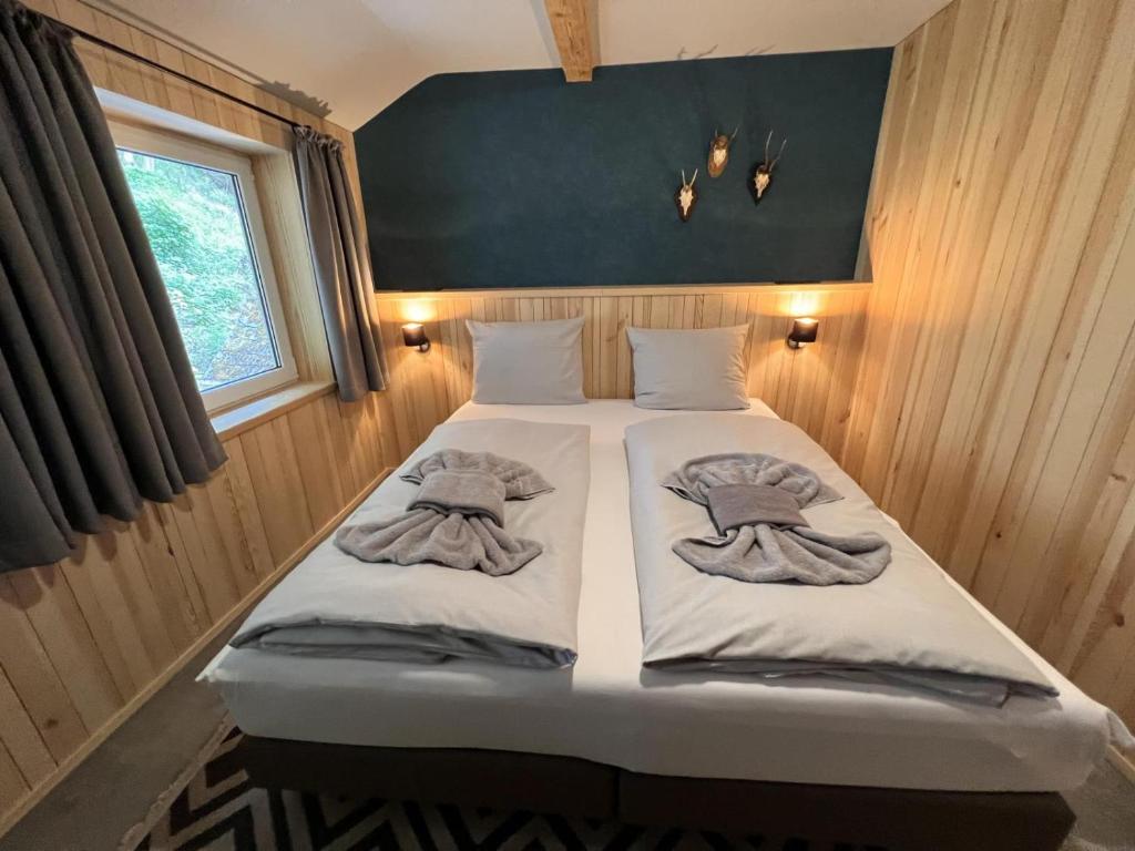 a bed in a small room with towels on it at Haus Bergquell App 7 in Willingen