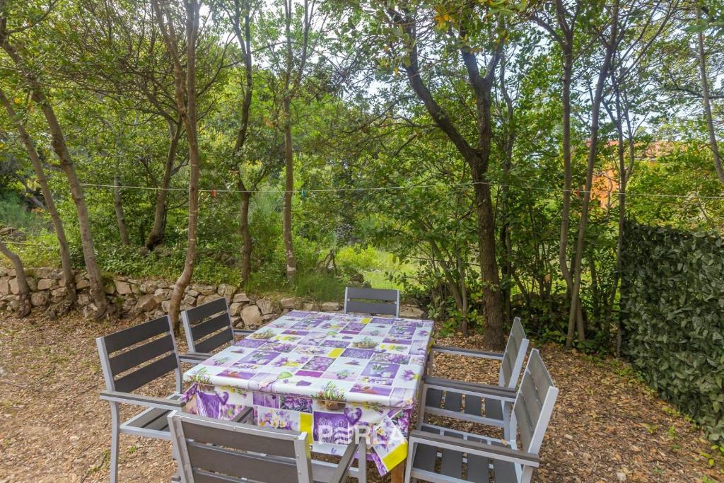 a table with two chairs and a table with a table cloth at House ALEXANDRA in Nerezine