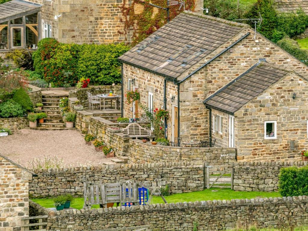 an old stone house with a stone wall at 2 Bed in Harrogate 79165 in Weeton