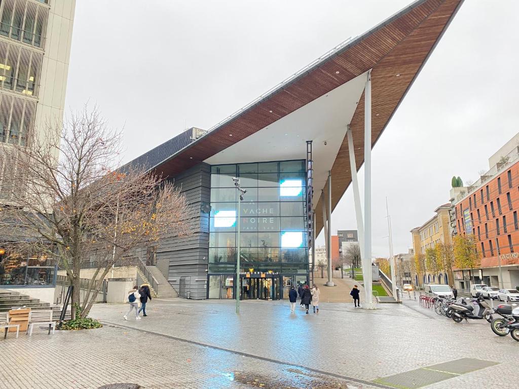 a large building with people walking in front of it at Chez les deux garçons in Montrouge