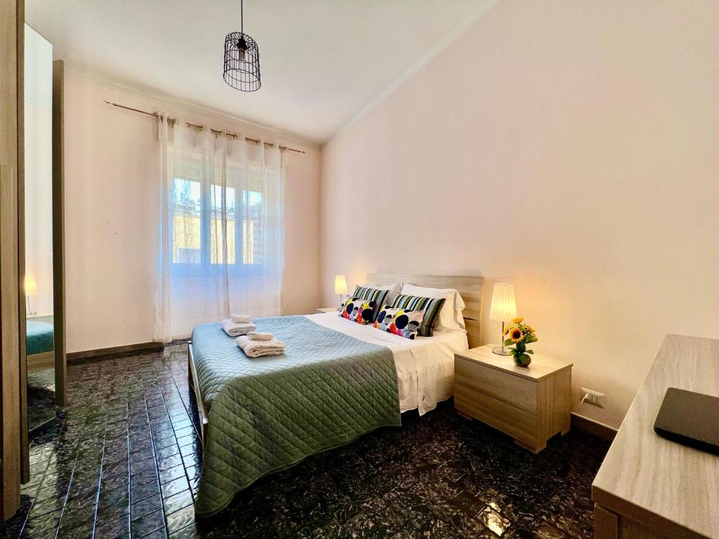 a bedroom with a bed and a window at Appartamento Cagliari Centro in Cagliari