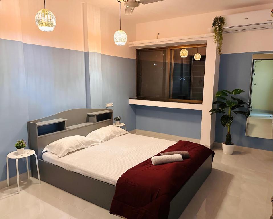 a bedroom with a large bed in a room at Jade Apartments- WiFi AC Smart Tv Kitchen in Pune