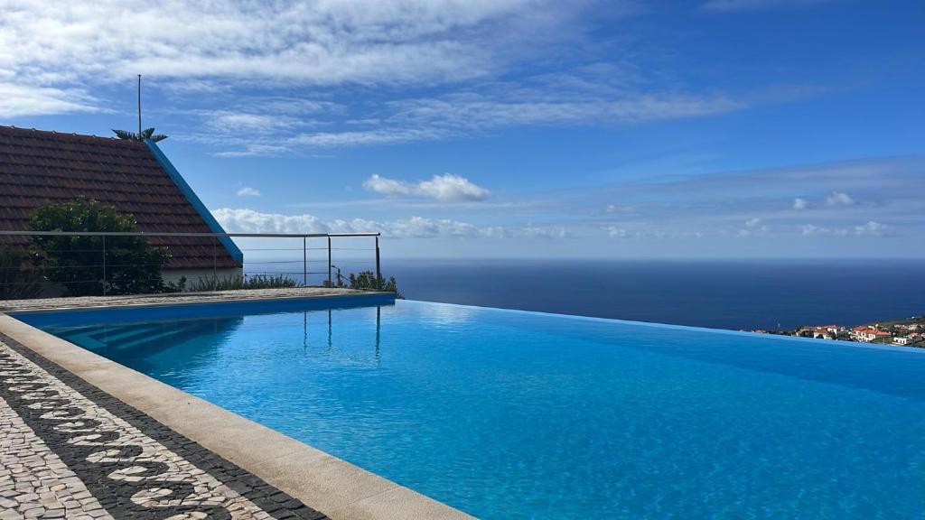a swimming pool with a view of the ocean at Lucky Lemons - Boutique Houses Madeira - 2 in Estreito da Calheta