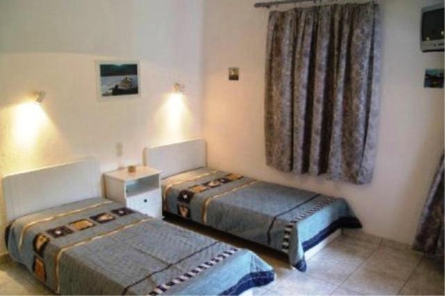 a room with two beds and a window at Villa Maro in Skopelos Town