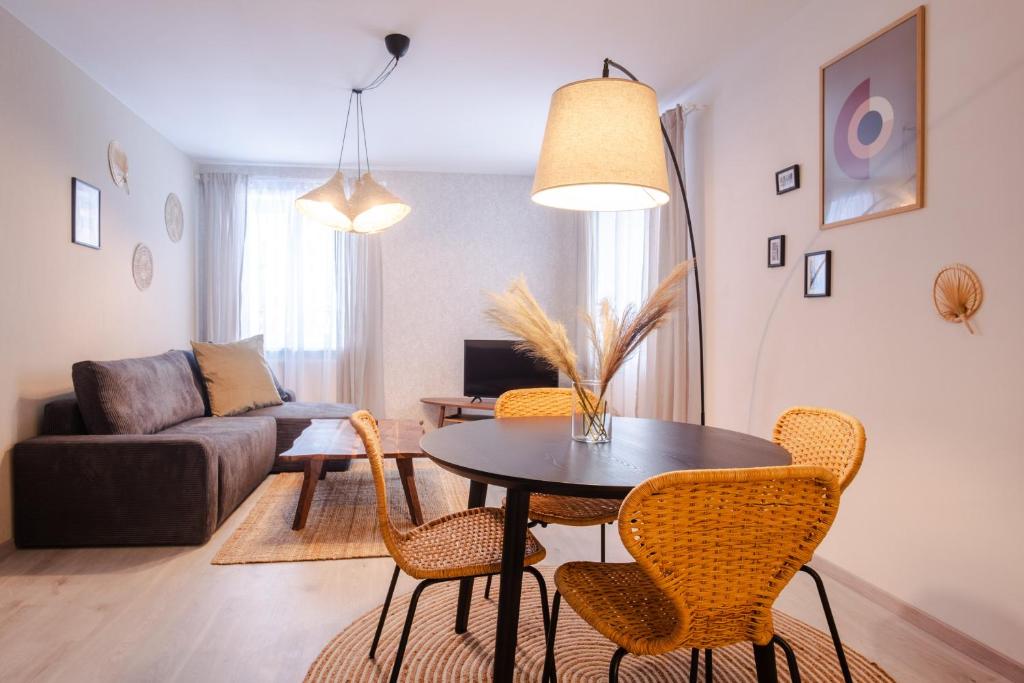a living room with a table and chairs and a couch at Boutique Apartment 23 in Jáchymov