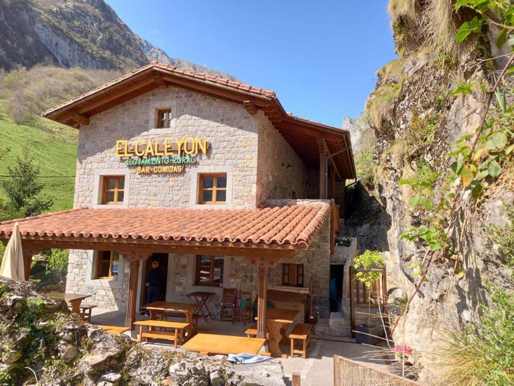 a building with a sign on the side of it at El Caleyon in Bulnes