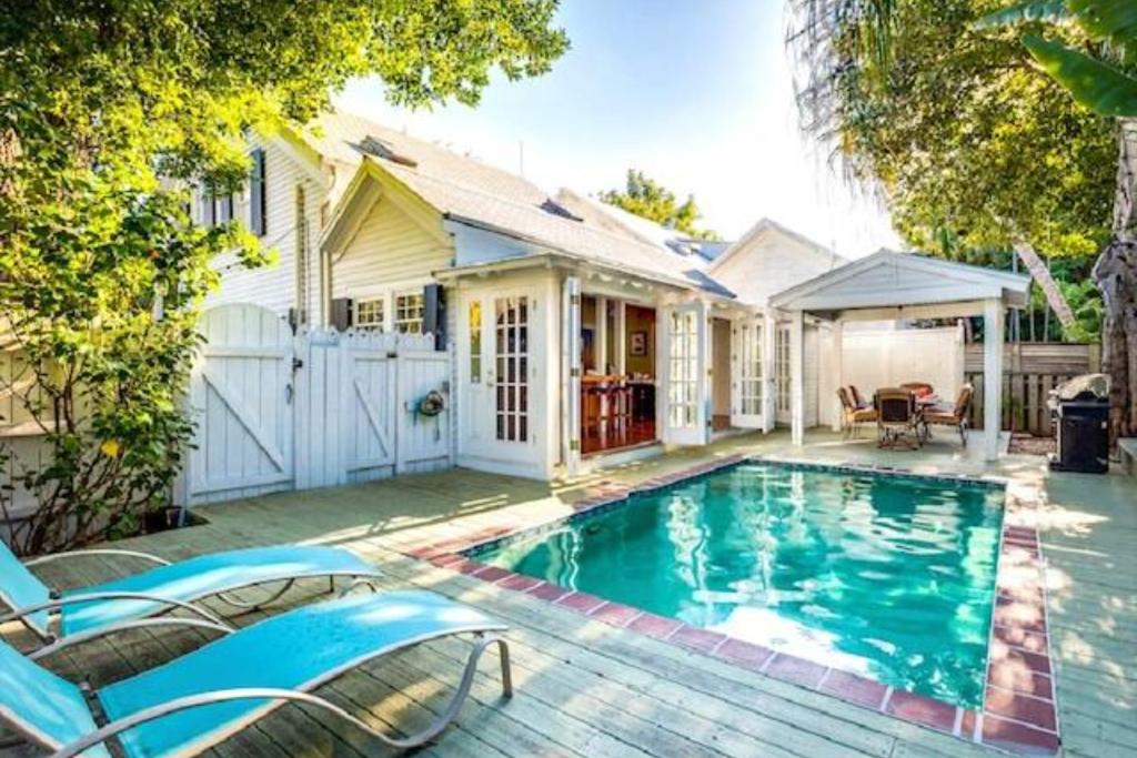 a swimming pool in front of a house at Casa de Rosalie by AvantStay Great Location w Pool BBQ Outdoor Dining Month Long Stays Only in Key West