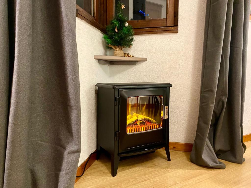 a fireplace sitting on the floor next to a wall at Les Sommets Studio in Chamonix-Mont-Blanc