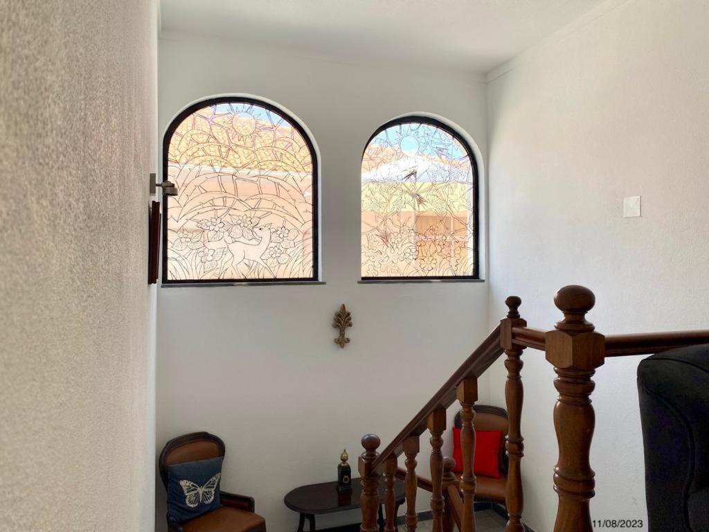 two windows in a room with a stairway at BLife Aerya private rooms in Faro