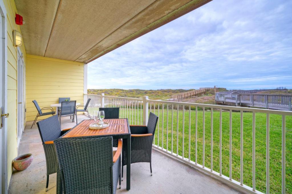 a patio with a table and chairs on a balcony at Salt Sun by AvantStay Beach Access Pool in Port Aransas