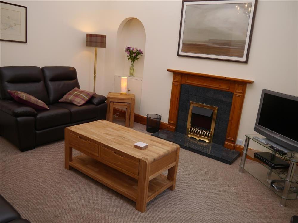 a living room with a couch and a fireplace at Number 48 in Dumfries