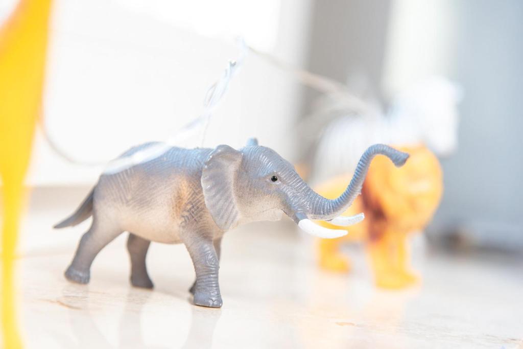 a plastic toy elephant walking on a floor at Gosewehr GbR in Hooksiel