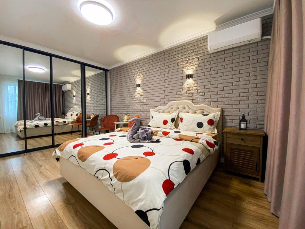 une chambre avec un lit et un mur de briques dans l'établissement Sunny Apartment, à Chişinău