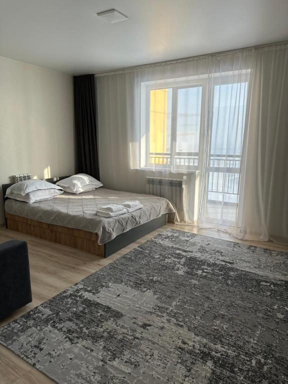 Säng eller sängar i ett rum på Apartment on Satpayeva 55/8