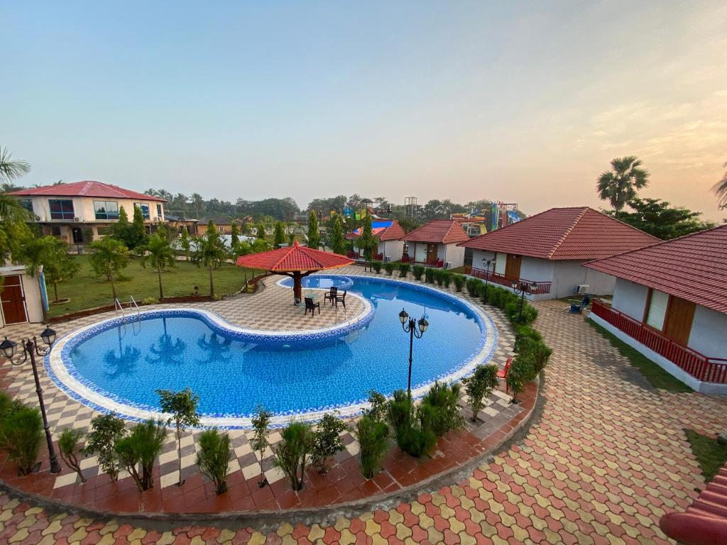 an overhead view of a swimming pool at a resort at DAN Resorts & Weddings in Boisar