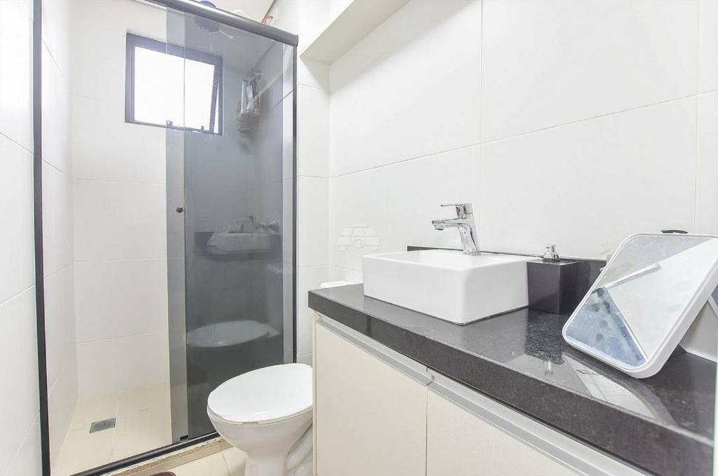 a white bathroom with a sink and a toilet at champs frente mar ao sol in Balneário Camboriú