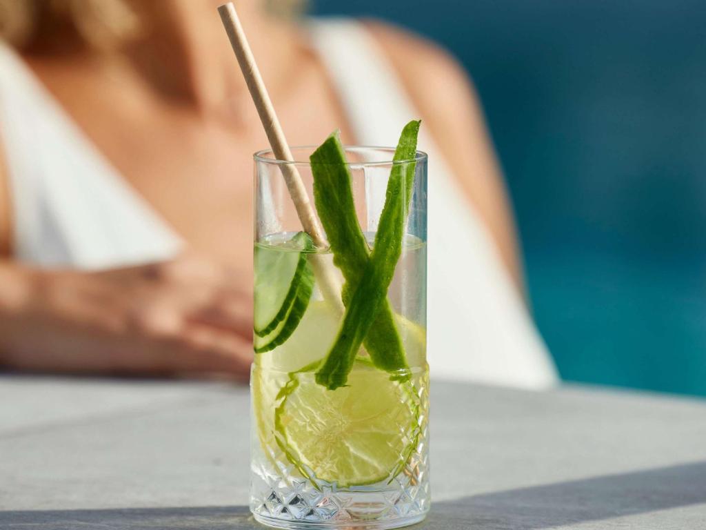 a glass with a green drink with a stick in it at Sofitel Golfe d'Ajaccio Thalassa Sea & Spa in Ajaccio