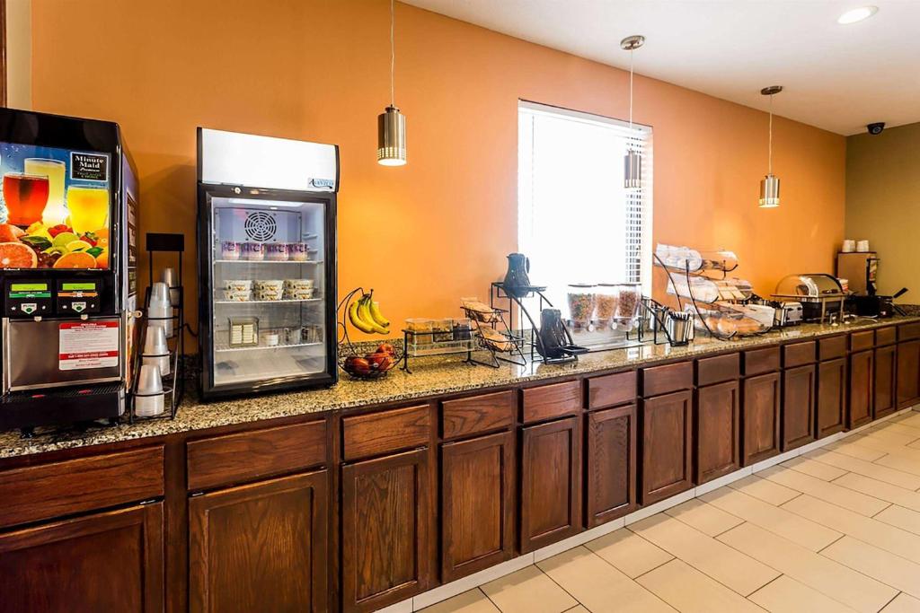 a kitchen with a counter with a refrigerator at Days Inn by Wyndham Round Rock in Round Rock