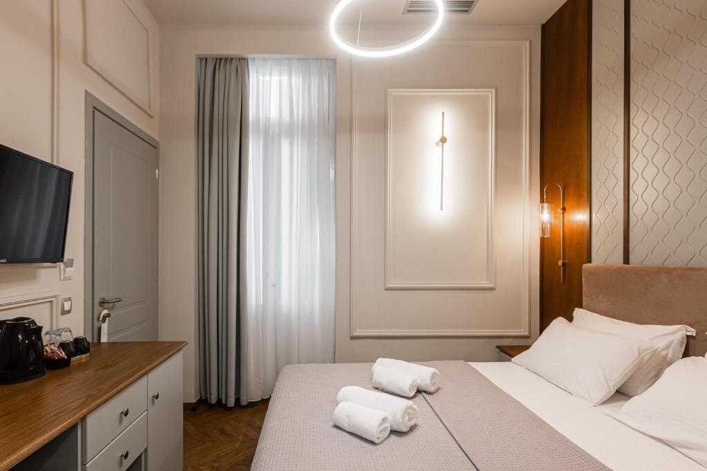 Postel nebo postele na pokoji v ubytování King Othon Boutique Hotel
