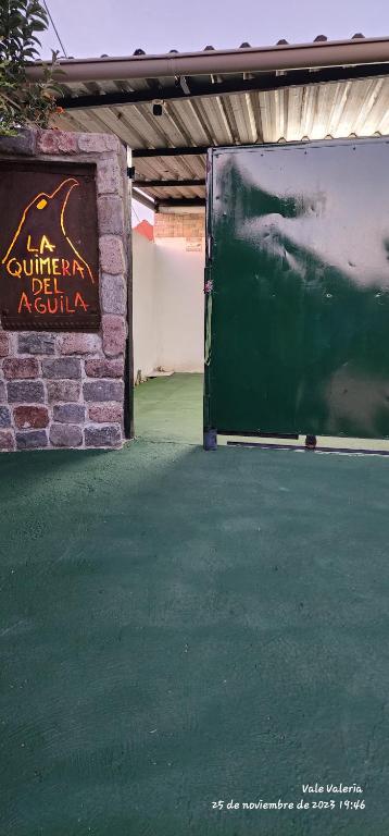 a entrance to a building with a sign on it at La Quimera del Águila in Atlántida