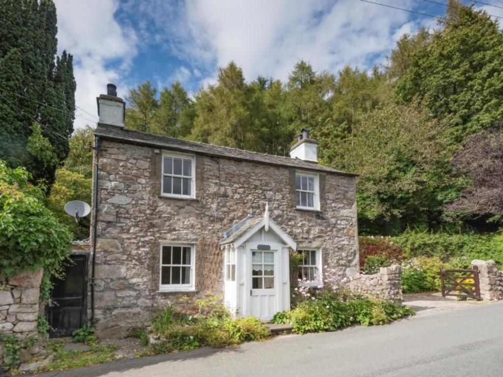 an old stone house with a white door at 3 Bed in Eskdale SZ416 in Santon Bridge