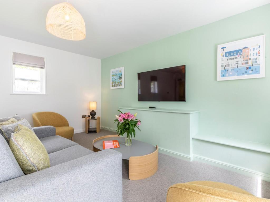 a living room with a couch and a tv at 2 Bed in St. Mellion 87715 in St Mellion