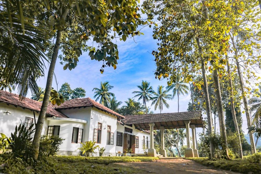 una casa con palmeras delante en Villa Milla Walauwa en Matale