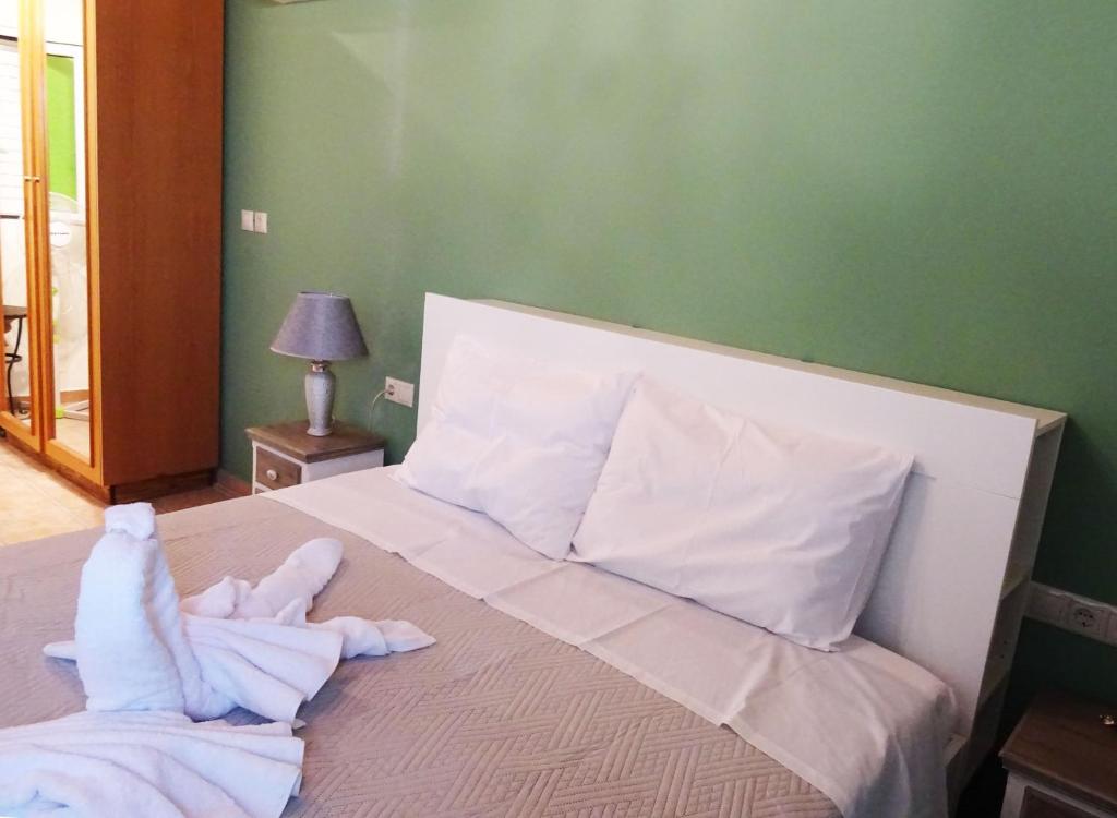 a bedroom with a bed with towels on it at Nadia's House 1 in Afantou