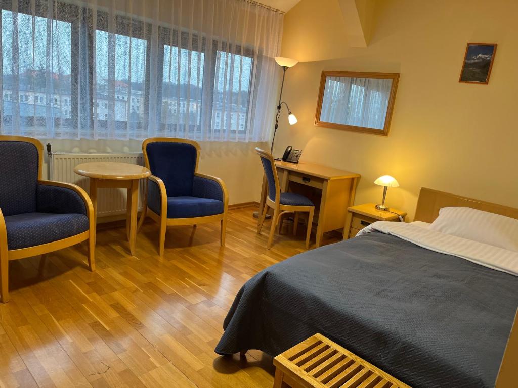 Postel nebo postele na pokoji v ubytování Hotel Uniwersytecki