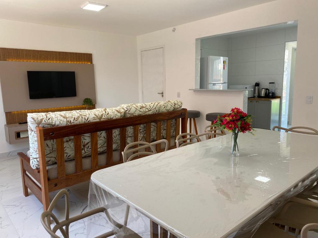 a dining room with a table and a couch at Apartamento 1 quadra do mar in Pontal do Paraná