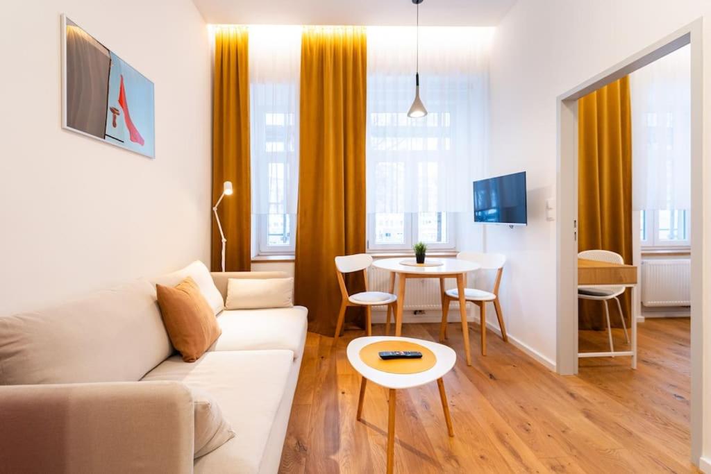 a living room with a white couch and a table at Cosy Apartment Koliste 25 in Brno