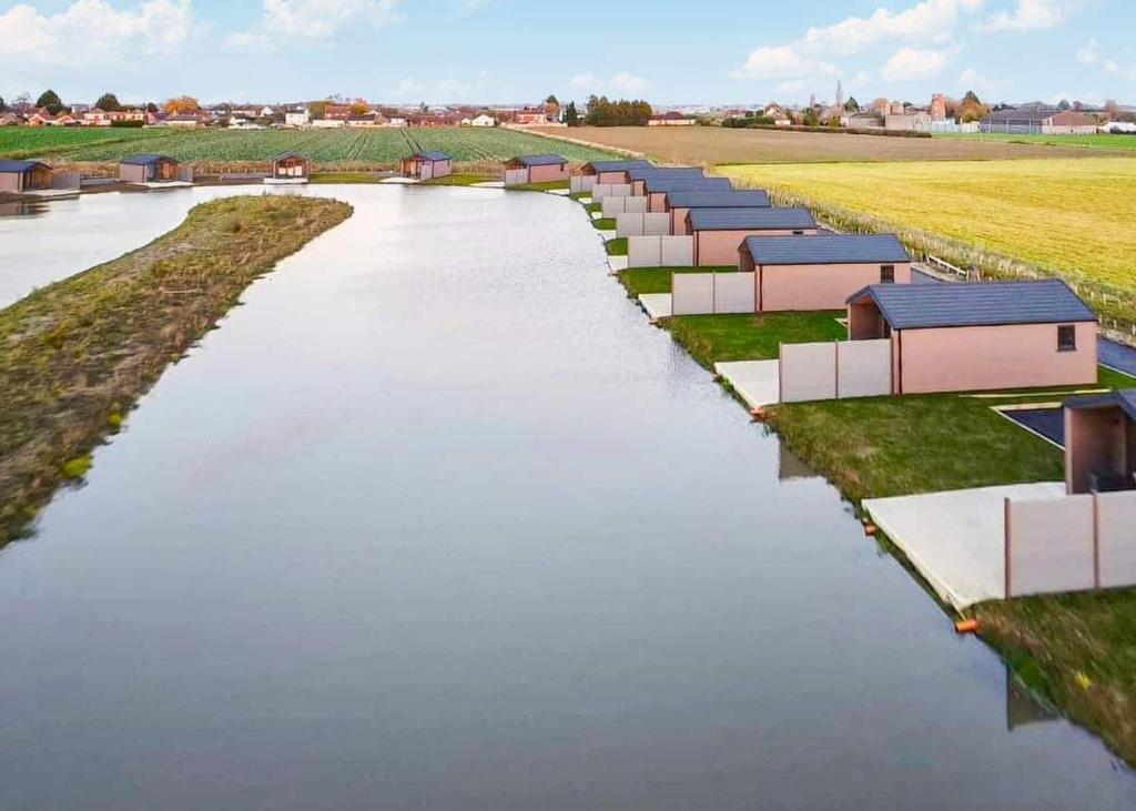 an artist rendering of a river with houses on it at Lakeside Fishing Retreats in Old Leake