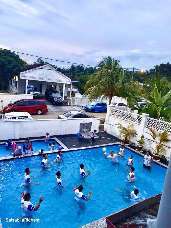 a group of people in a swimming pool at MY VILLA PD in Port Dickson