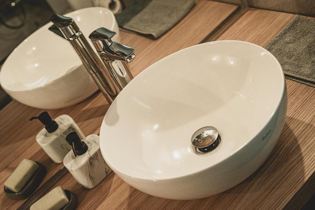 a white bathroom sink with a silver faucet at Artists' Nest in Marsaskala