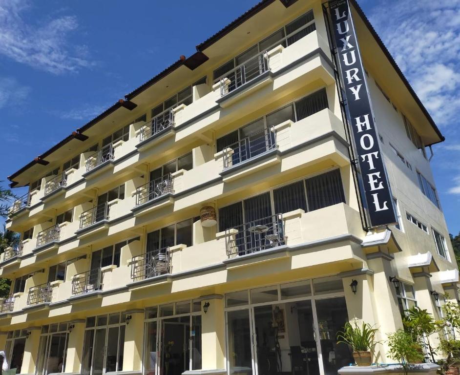 a hotel with a sign on the side of it at KOH CHANG LUXURY HOTEL in Ban Map Khangkhao