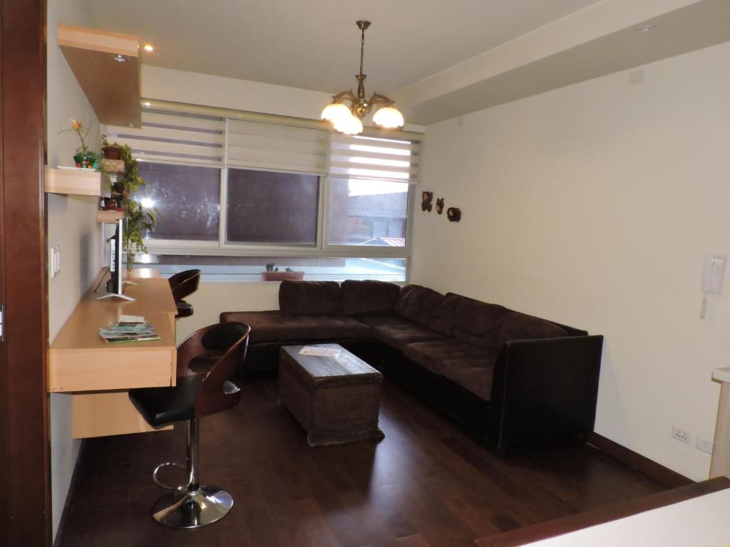 a living room with a couch and a table at Altos del Parque/Espacio Ideal in Cochabamba