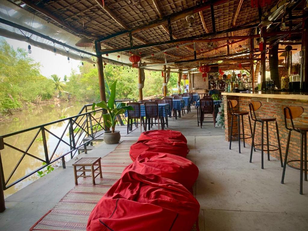 a row of red blankets on the floor of a restaurant at Song Ngư Pisces Homestay in Can Tho