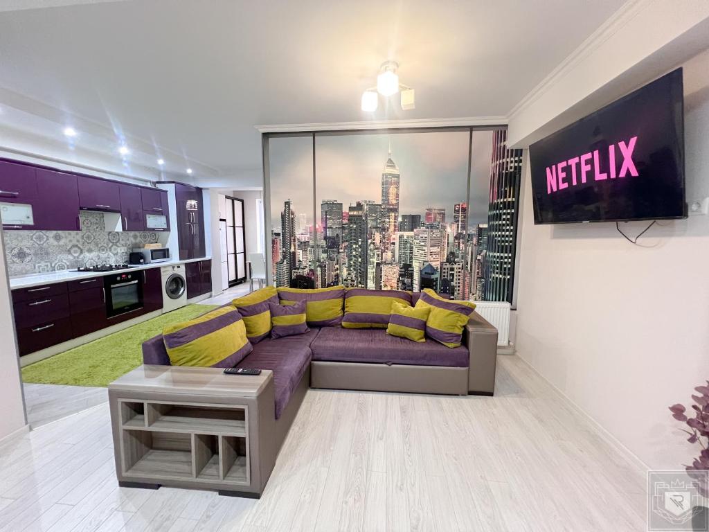 a living room with a purple couch and yellow pillows at RentHouse Apartments Deep Purple in Chişinău