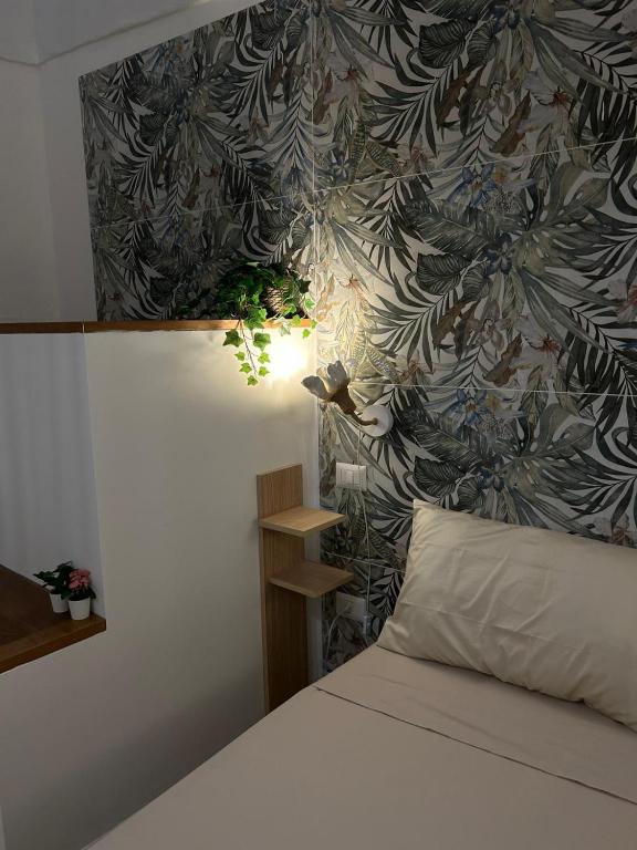 a bedroom with a bed with a floral wallpaper at Meridiem in Molfetta