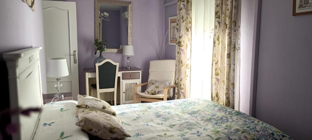 a bedroom with a bed and a window at Encanto de Granada - Parking gratuito in Armilla