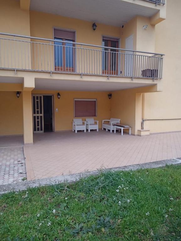 a building with two tables and a balcony at B&B paradiso in Paganica