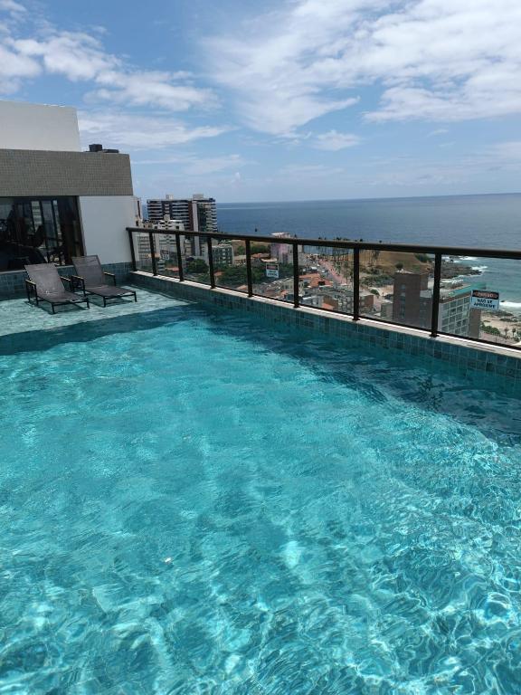 a large swimming pool on top of a building at Barra Caravela Studio in Salvador