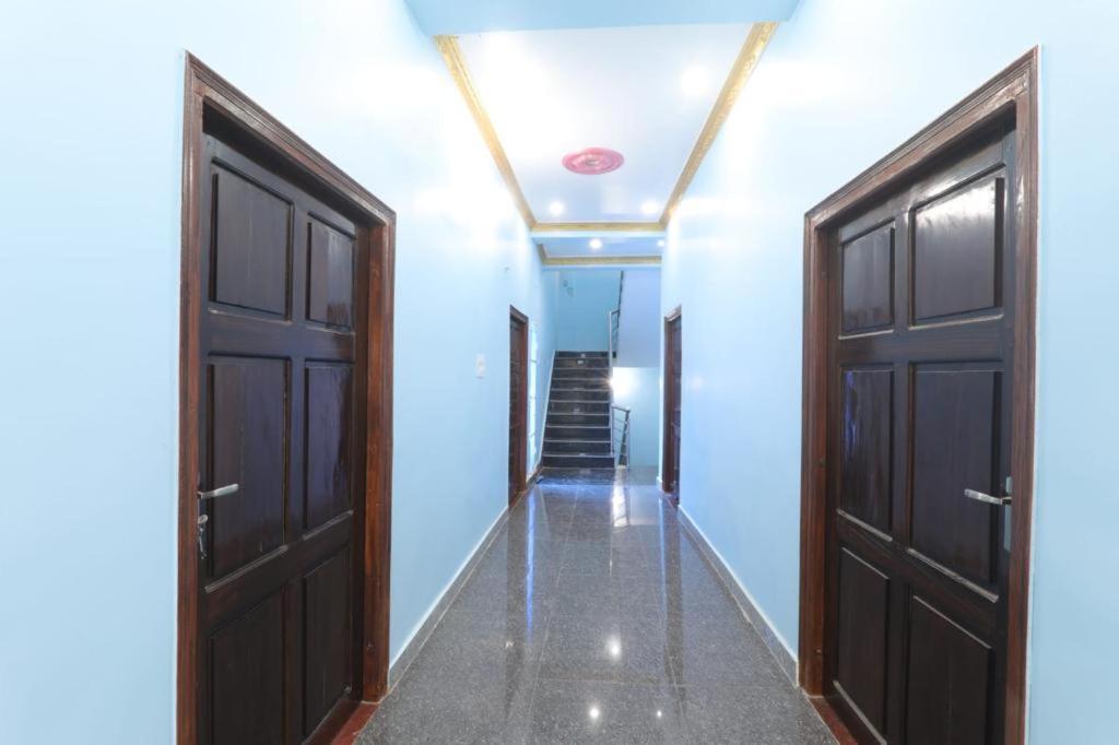an empty hallway with two doors and a staircase at Hotel Atithi Satkar , Gobarsahi in Muzaffarpur