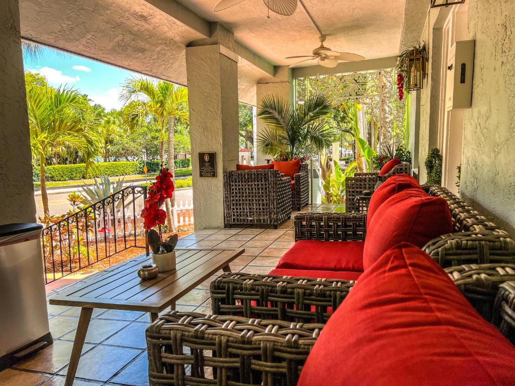 a room with chairs and red pillows on a balcony at Vinoy House in St Petersburg