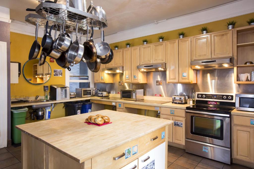 a kitchen with stainless steel appliances and a stove top oven at HI San Francisco Downtown Hostel in San Francisco