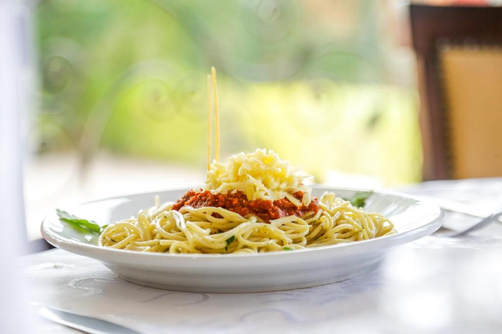 a plate of pasta with sauce on a table at Complexe El Bassatine in Beni Mellal