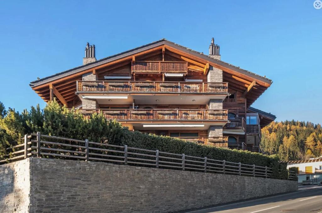 a large wooden house on top of a wall at Magnificent flat in Crans-Montana - 856 in Crans-Montana
