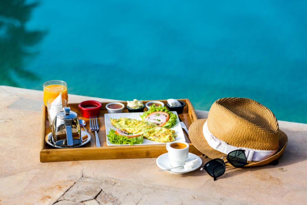 a tray of food and a hat and a tray of food at Complexe El Bassatine in Beni Mellal
