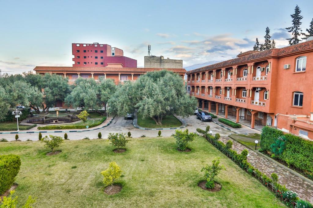 a park in the middle of a city with buildings at Complexe El Bassatine in Beni Mellal