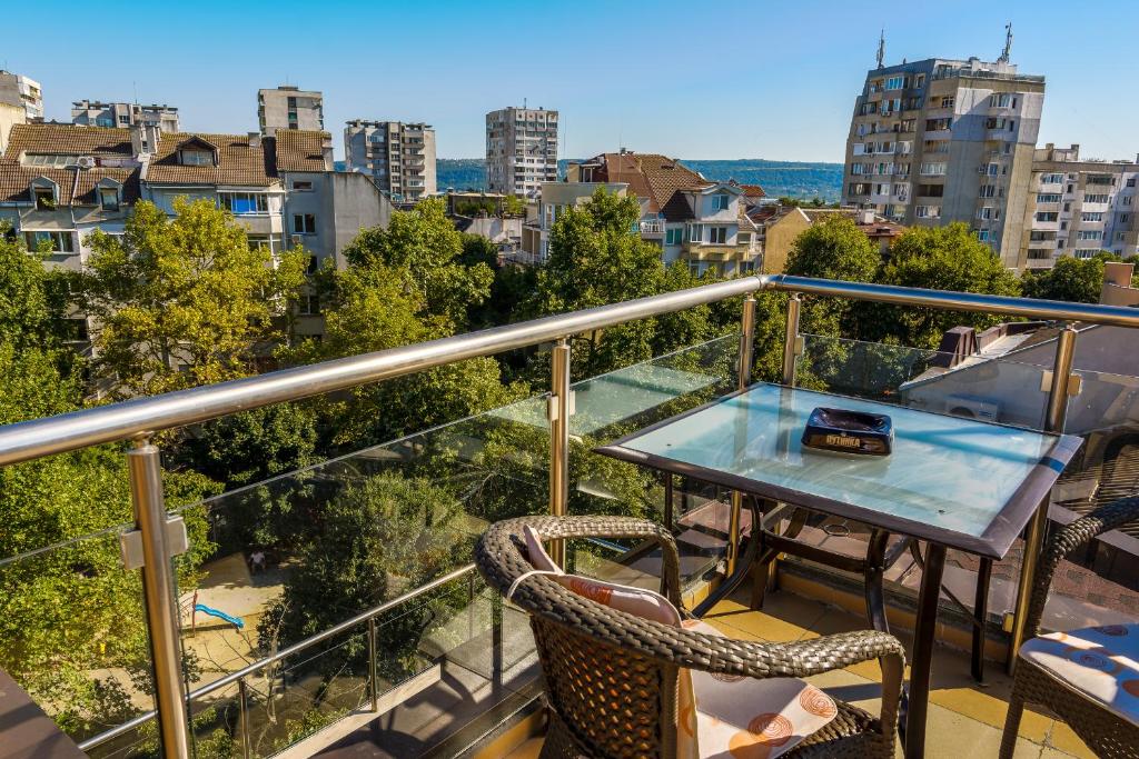 a balcony with a table and chairs and a view at Studio Marten in Varna City